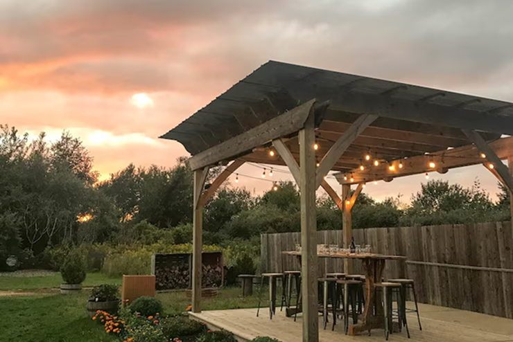 power gazebo with outdoor seating and lighting in backyard landscape design in California
